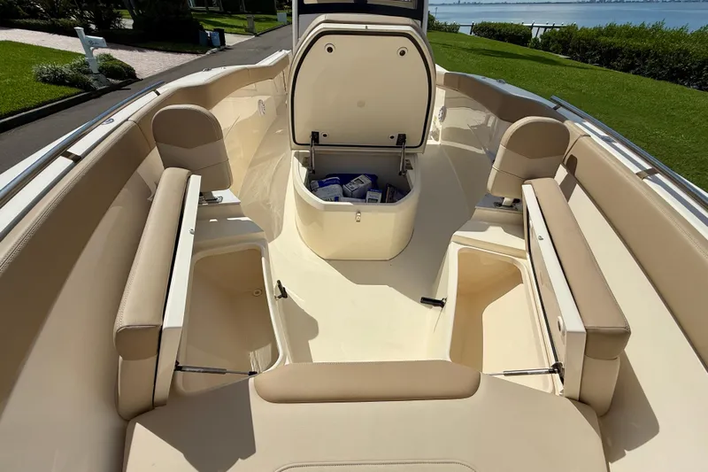  Yacht Photos Pics 2025 Scout 240 XSF boat interior with beige seating and storage compartments.
