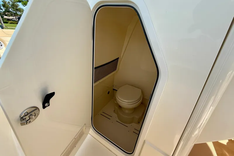  Yacht Photos Pics 2025 Scout 240 XSF boat interior with compact marine toilet.