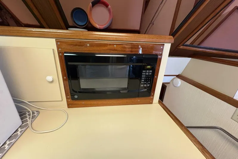 Keepem Flying Yacht Photos Pics Microwave in 1985 Hatteras 60 Enclosed Bridge yacht kitchen with wood trim.