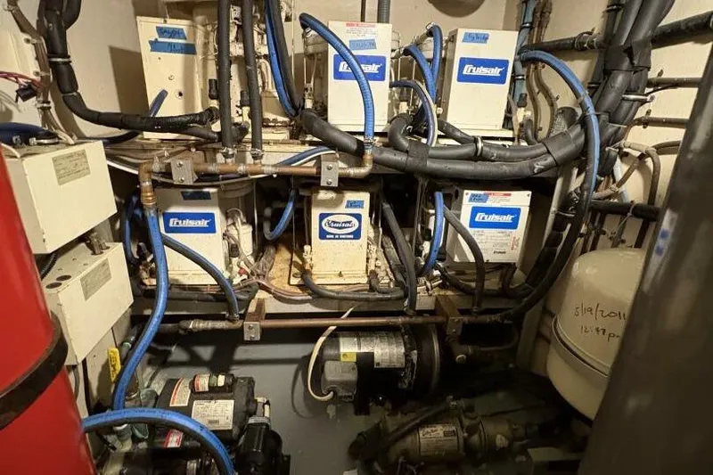 Keepem Flying Yacht Photos Pics Engine room of 1985 Hatteras 60 enclosed bridge with Cruisair units and piping.