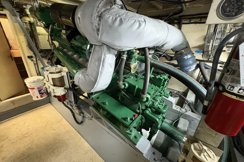 Keepem Flying Yacht Photos Pics Engine room of 1985 Hatteras 60 enclosed bridge yacht, featuring green machinery.