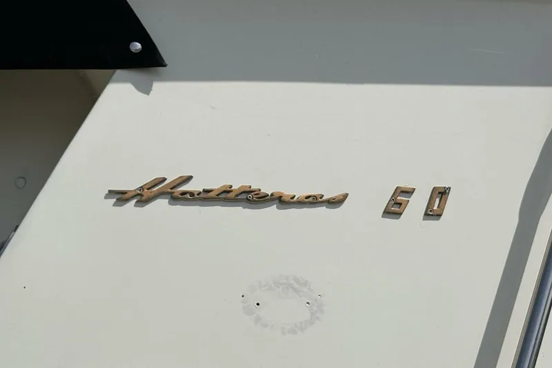 Keepem Flying Yacht Photos Pics 1985 Hatteras 60 Enclosed Bridge yacht emblem on white surface.