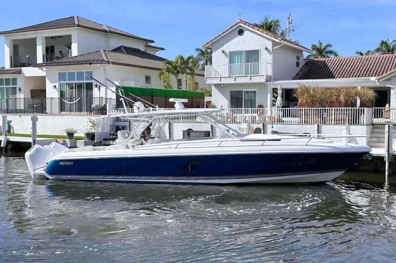  Yacht Photos Pics 2015 Intrepid 400 Cuddy boat docked near waterfront homes.