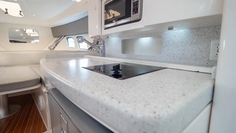  Yacht Photos Pics 2015 Intrepid 400 Cuddy interior with modern kitchen and sleek countertop design.
