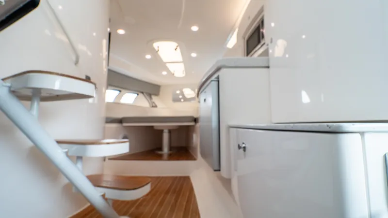  Yacht Photos Pics Interior of 2015 Intrepid 400 Cuddy boat, featuring modern design and wood flooring.