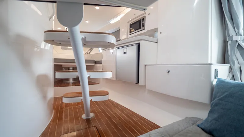  Yacht Photos Pics Interior of 2015 Intrepid 400 Cuddy, featuring modern kitchen and wooden flooring.