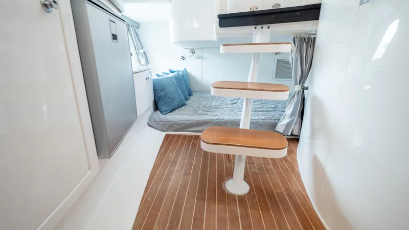  Yacht Photos Pics 2015 Intrepid 400 Cuddy interior with wooden steps and cozy sleeping area.