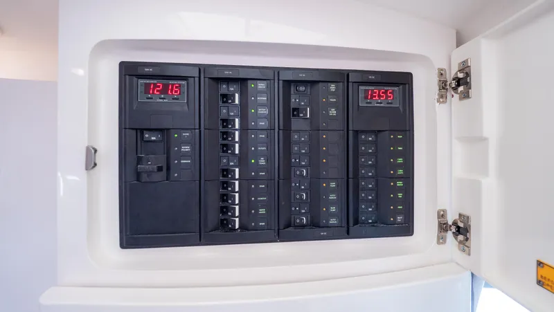  Yacht Photos Pics Electrical panel inside 2015 Intrepid 400 Cuddy boat, showing circuit breakers and digital displays.