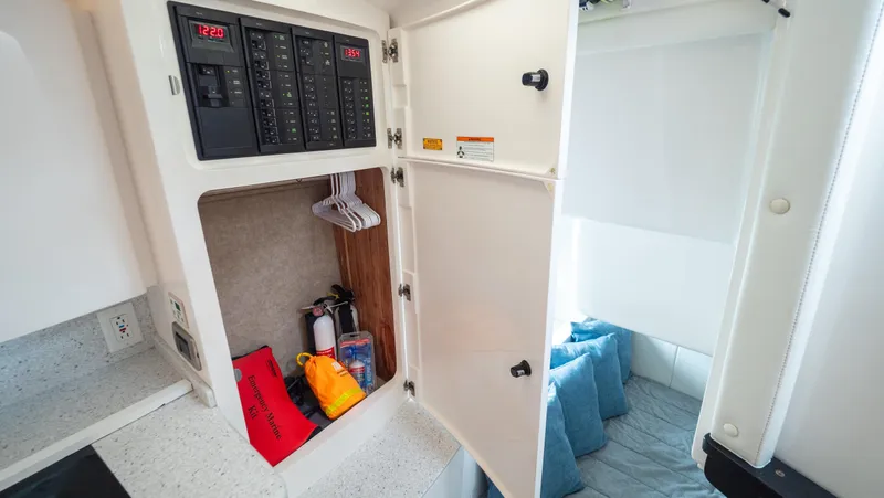  Yacht Photos Pics 2015 Intrepid 400 Cuddy interior with open storage and electrical panel.