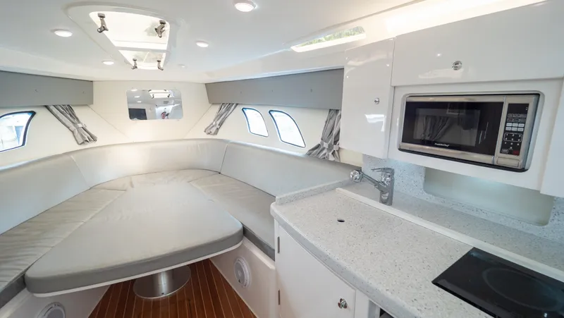  Yacht Photos Pics Interior of 2015 Intrepid 400 Cuddy boat with modern kitchen and seating area.