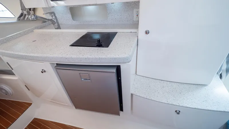  Yacht Photos Pics 2015 Intrepid 400 Cuddy interior kitchen with stove and fridge.