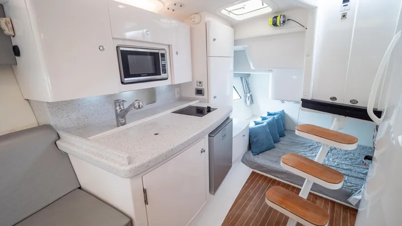  Yacht Photos Pics 2015 Intrepid 400 Cuddy interior with kitchenette, seating, and modern amenities.