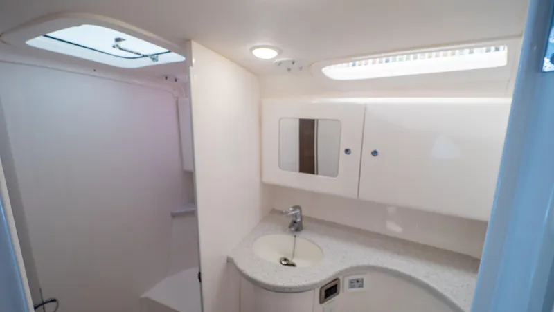  Yacht Photos Pics 2015 Intrepid 400 Cuddy bathroom with modern fixtures and white cabinetry.