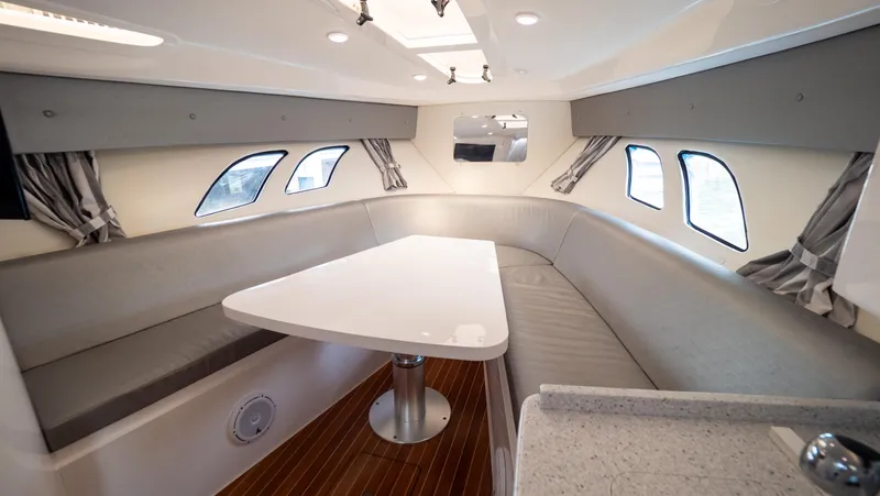  Yacht Photos Pics 2015 Intrepid 400 Cuddy interior with sleek seating and modern table design.