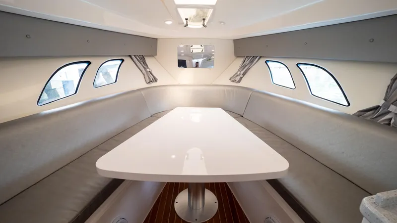  Yacht Photos Pics Interior of 2015 Intrepid 400 Cuddy boat with sleek seating and table.