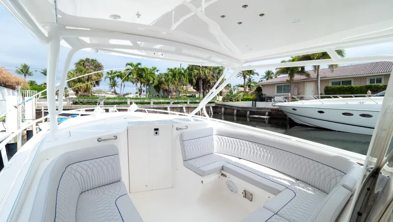  Yacht Photos Pics 2015 Intrepid 400 Cuddy boat interior with white seating and waterfront view.