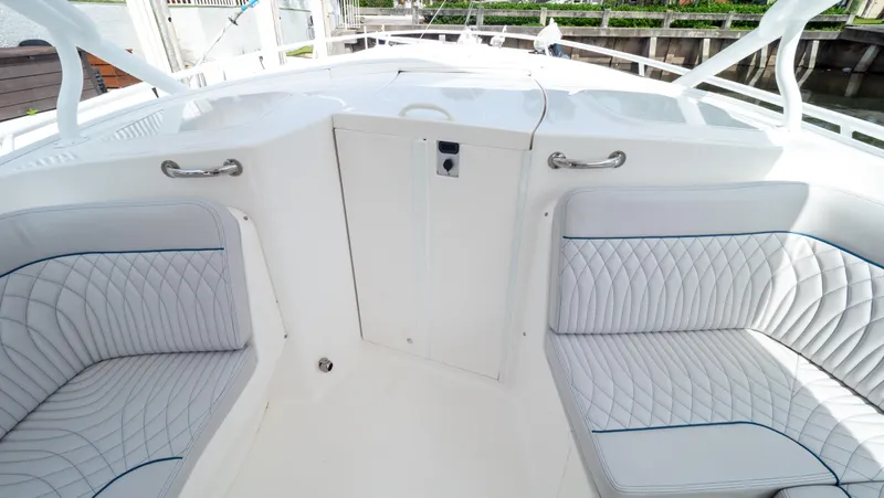  Yacht Photos Pics 2015 Intrepid 400 Cuddy interior with white cushioned seating and sleek design.