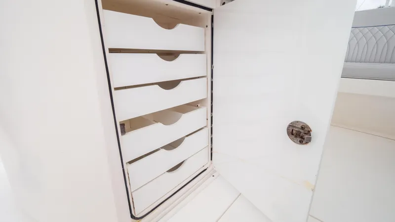  Yacht Photos Pics 2015 Intrepid 400 Cuddy interior storage drawers with open door.