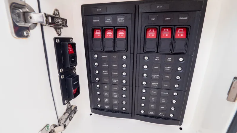  Yacht Photos Pics Electrical panel on a 2015 Intrepid 400 Cuddy boat, featuring multiple switches and circuit breakers.