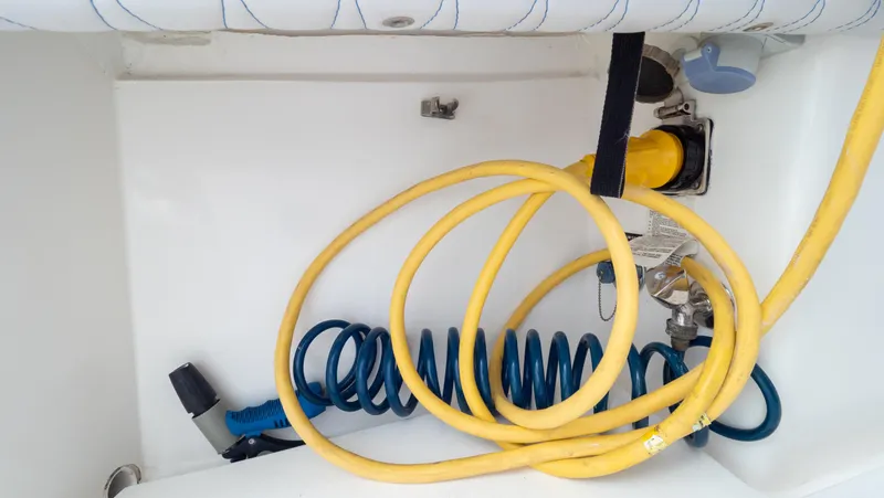  Yacht Photos Pics Coiled hoses in the storage compartment of a 2015 Intrepid 400 Cuddy boat.