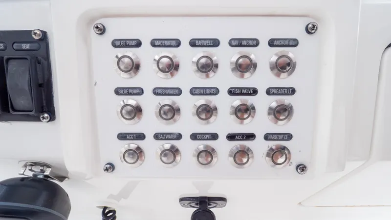 Yacht Photos Pics Control panel of a 2015 Intrepid 400 Cuddy boat with labeled switches.