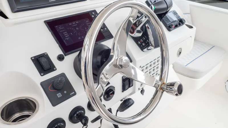  Yacht Photos Pics Steering wheel and controls of a 2015 Intrepid 400 Cuddy boat.