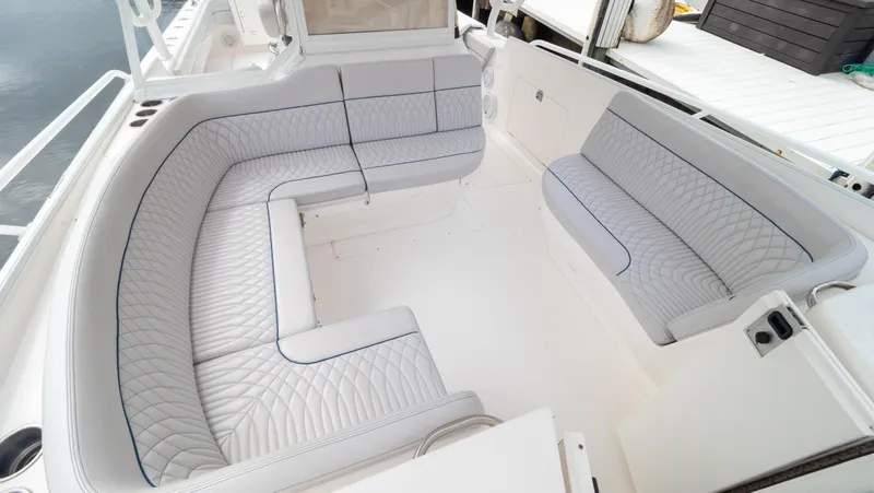  Yacht Photos Pics Luxurious seating area on a 2015 Intrepid 400 Cuddy boat, featuring elegant white upholstery.