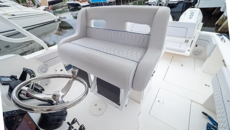 Yacht Photos Pics 2015 Intrepid 400 Cuddy boat interior with steering wheel and seating.