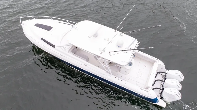  Yacht Photos Pics 2015 Intrepid 400 Cuddy boat with triple outboard engines on water.