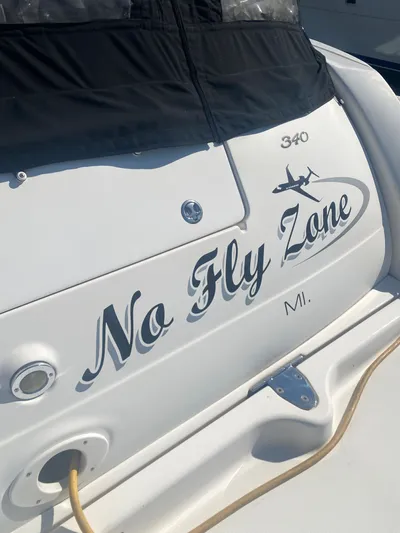 No Fly Zone Yacht Photos Pics 2003 Sea Ray 340 Sundancer boat with "No Fly Zone" name on the stern.