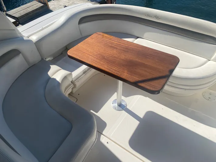 No Fly Zone Yacht Photos Pics 2003 Sea Ray 340 Sundancer boat interior with wooden table and white seating.