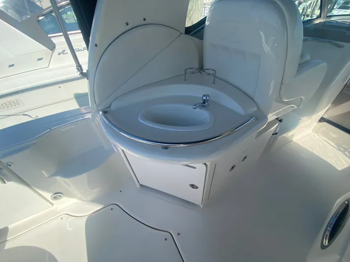 No Fly Zone Yacht Photos Pics 2003 Sea Ray 340 Sundancer boat interior with compact sink and storage area.