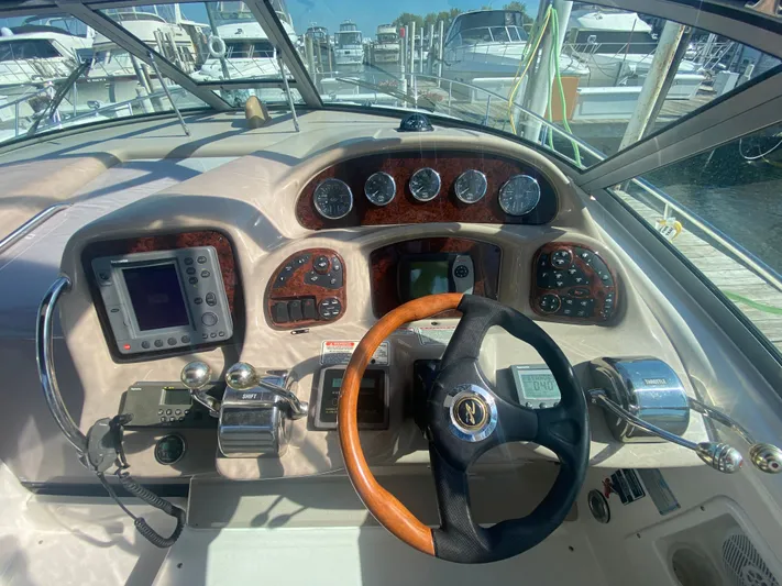 No Fly Zone Yacht Photos Pics 2003 Sea Ray 340 Sundancer helm with wood accents and modern navigation equipment.