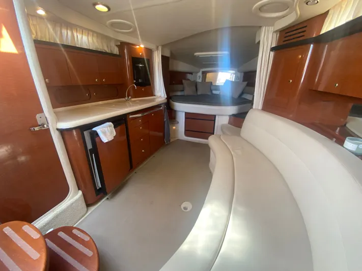 No Fly Zone Yacht Photos Pics Interior of 2003 Sea Ray 340 Sundancer yacht with kitchen and seating area.