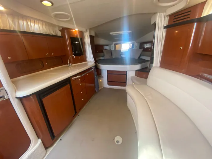 No Fly Zone Yacht Photos Pics Interior of 2003 Sea Ray 340 Sundancer yacht with kitchenette and seating area.