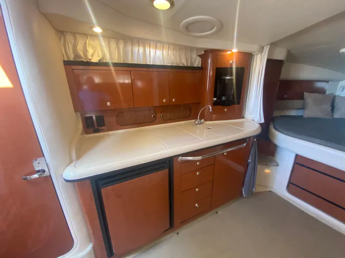 No Fly Zone Yacht Photos Pics 2003 Sea Ray 340 Sundancer cabin interior with kitchenette and bed.