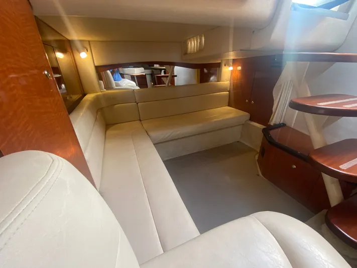 No Fly Zone Yacht Photos Pics Interior of 2003 Sea Ray 340 Sundancer yacht with beige seating and wooden accents.