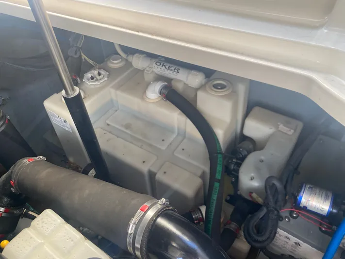 No Fly Zone Yacht Photos Pics Engine compartment of a 2003 Sea Ray 340 Sundancer boat, showing hoses and components.