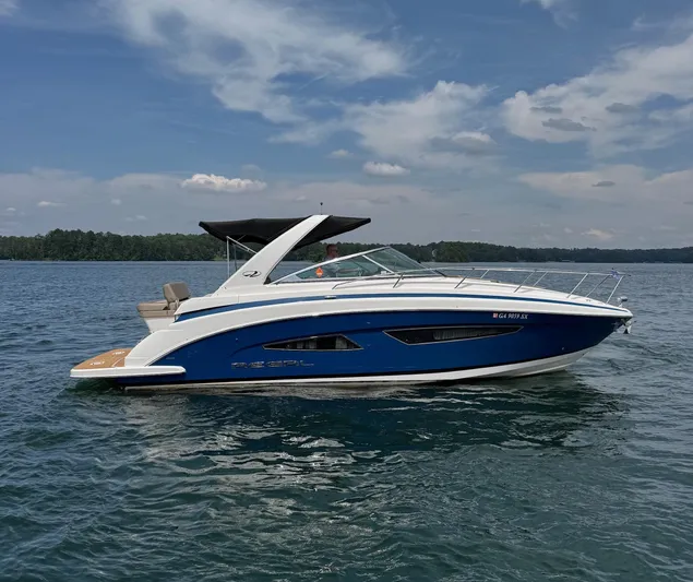 Wine-n-down Yacht Photos Pics 2014 Regal 32 Express boat on calm water under a clear sky.