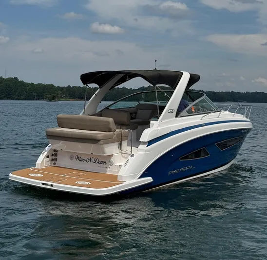 Wine-n-down Yacht Photos Pics 2014 Regal 32 Express boat on a lake, featuring sleek design and comfortable seating.