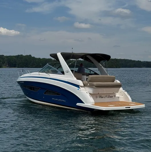 Wine-n-down Yacht Photos Pics 2014 Regal 32 Express boat cruising on a lake under a partly cloudy sky.