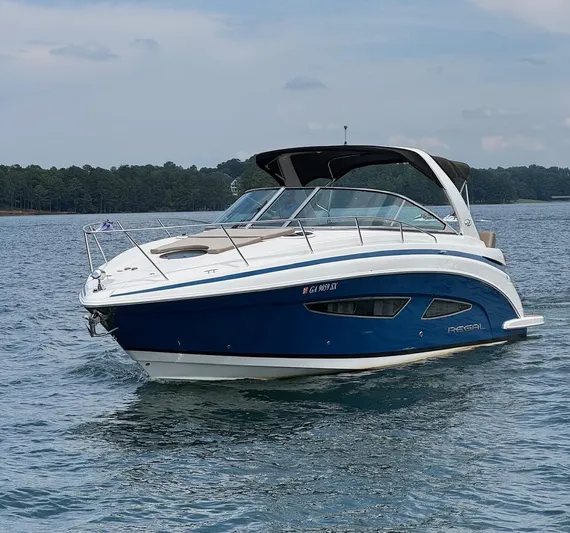 Wine-n-down Yacht Photos Pics 2014 Regal 32 Express boat on calm water, featuring sleek design and blue hull.