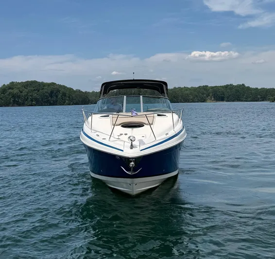 Wine-n-down Yacht Photos Pics 2014 Regal 32 Express boat on a calm lake under a clear sky.