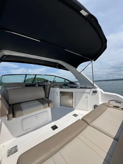 Wine-n-down Yacht Photos Pics 2014 Regal 32 Express boat interior with seating and canopy on a calm lake.