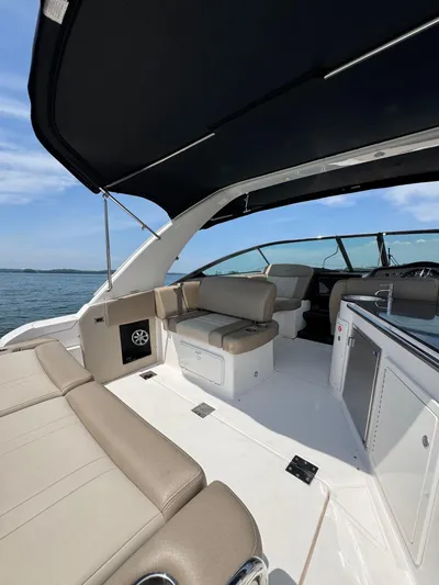 Wine-n-down Yacht Photos Pics 2014 Regal 32 Express boat interior with beige seating and sleek design on open water.