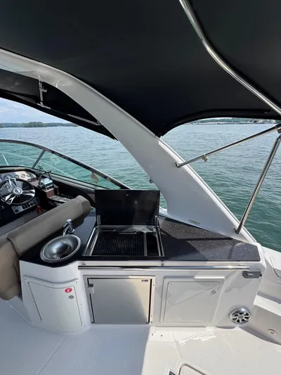 Wine-n-down Yacht Photos Pics 2014 Regal 32 Express yacht with outdoor kitchen and scenic water view.