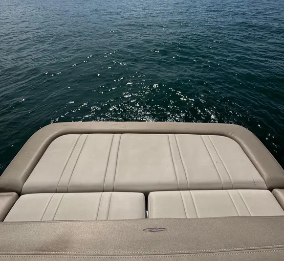 Wine-n-down Yacht Photos Pics Rear view of 2014 Regal 32 Express boat with water in the background.