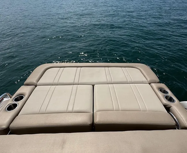 Wine-n-down Yacht Photos Pics 2014 Regal 32 Express boat with beige seating overlooking the water.