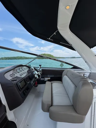 Wine-n-down Yacht Photos Pics 2014 Regal 32 Express boat interior with steering wheel and seating, on a sunny day.