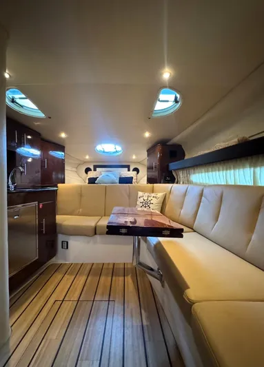 Wine-n-down Yacht Photos Pics Interior of a 2014 Regal 32 Express yacht with elegant seating and wooden flooring.